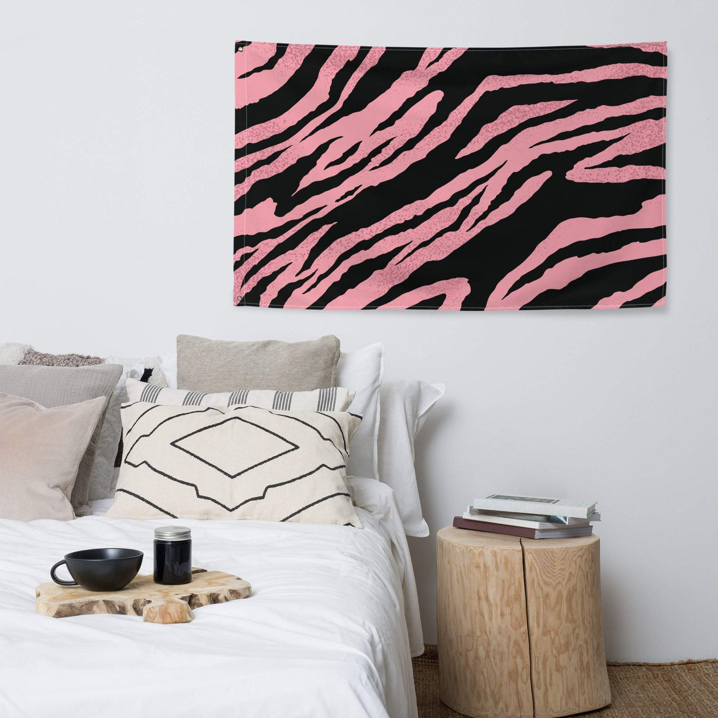 Unique pink and black zebra print flag made of durable polyester hanging above a bed in a modern bedroom setting
