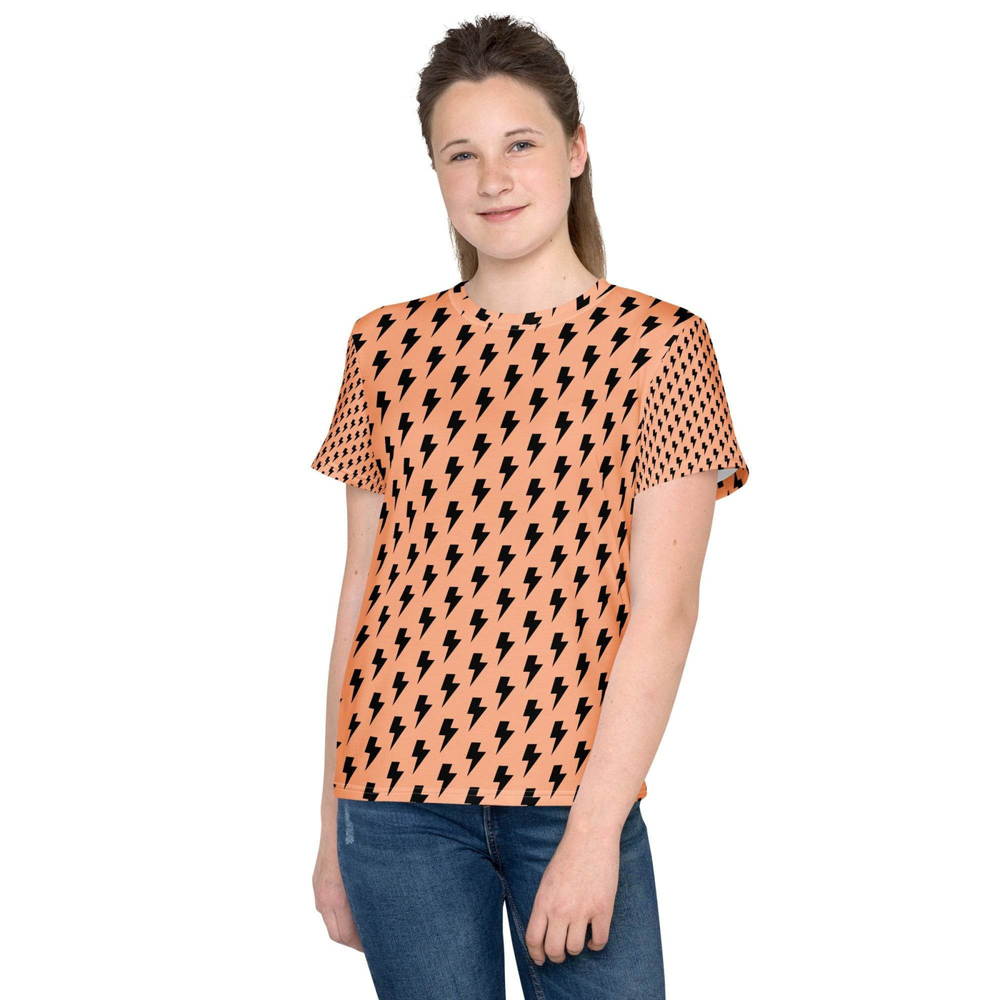 Teen wearing orange youth crew neck t-shirt with black lightning and triangle pattern paired with blue jeans