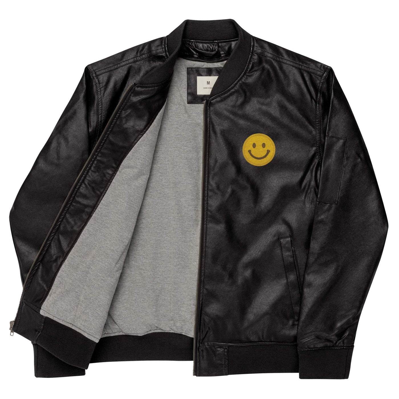 Black leather bomber jacket with smiley face patch and rib-knit collar, cuffs, and hem, featuring side pockets and inside lining.