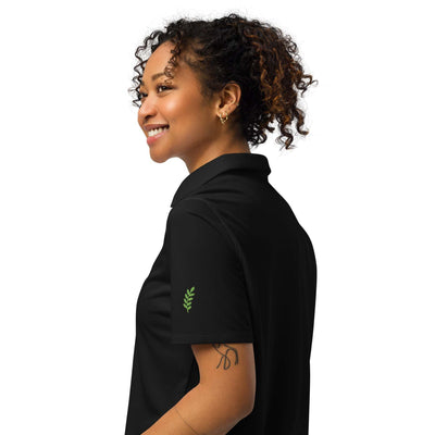 Under Armour women’s black polo shirt with anti-odor, breathable fabric and relaxed fit worn by smiling woman