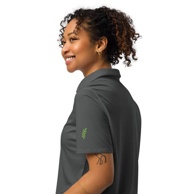 Under Armour® women’s gray polo with breathable, lightweight fabric and anti-odor technology worn by smiling woman