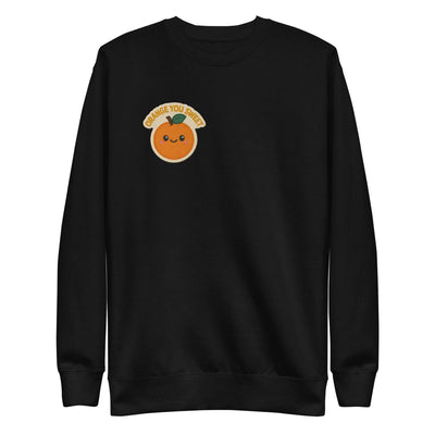 Black unisex premium sweatshirt with ribbed crew neck, long cuffs, flat hem, and cute orange graphic patch on chest.