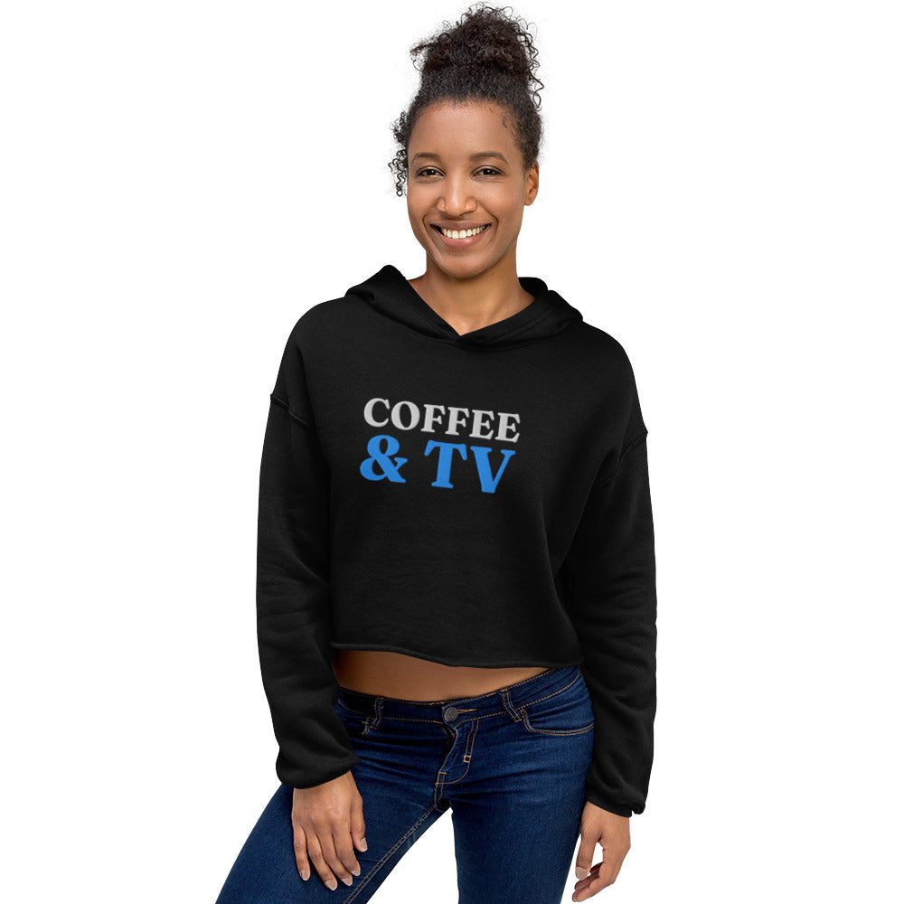 Woman wearing black crop hoodie with "COFFEE & TV" text and raw hem